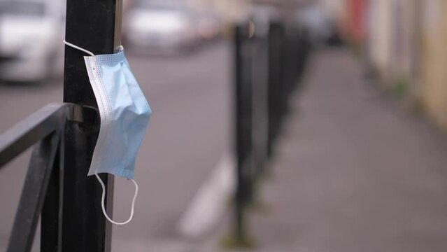 Surgical Mask Abandoned In The Street On A Roadside Hurdle