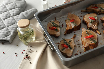 Delicious roasted ribs on white wooden table