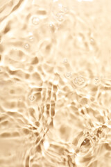 Closeup view of water with rippled surface on beige background