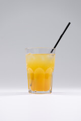fresh orange cold fruit duchesse drink with pear, ice, straw isolated