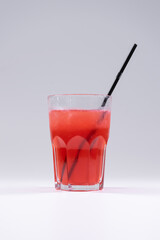 fresh cold fruit drink with barberry, ice, straw isolated