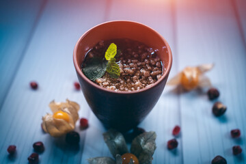 dessert with walnut nuts and honey in brown cup