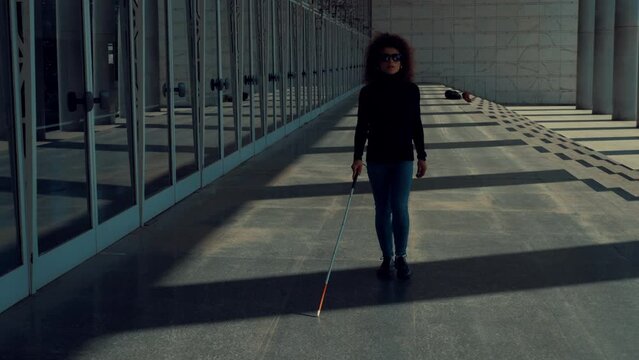 autonomy, handicap - young blind woman moves independently with her stick