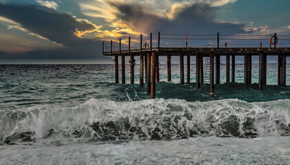 Storm in the Mediterranean Sea, Turkey, strong waves near the old wooden pier - 553626629
