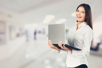 Smiling happy business woman manager using laptop