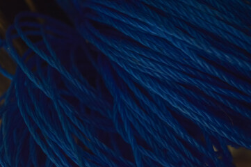 Selective focus of blue nylon rope. Abstract background.