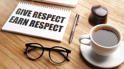 give respect earn respect, motivational and inspirational words in notebook on table with laptop, pen, glasses and cup of coffee.