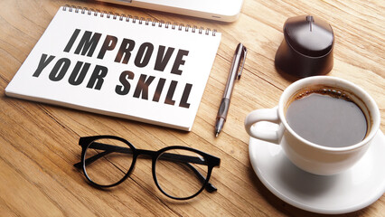 improve your skill, motivational and inspirational words in notebook on table with laptop and cup of coffee.