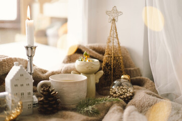 Christmas composition. Hot tea, candles, Christmas golden balls and decorations. Christmas holiday mood. Winter concept.