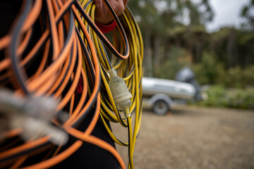 power lead on a building site, electrician with a power cable