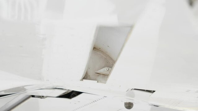 Close Up Airplane Wing on ground, Flaps Being Extended by Worm Screw.
