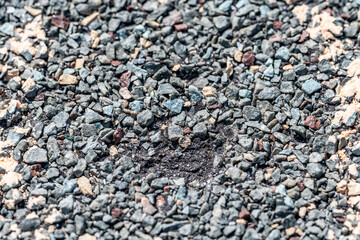 Macro of hail damage on a shingle residential roof circled with a chalk outline during a home...