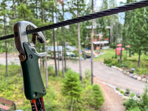 Selective focus on a safety clip used on a high wire ropes course - Powered by Adobe