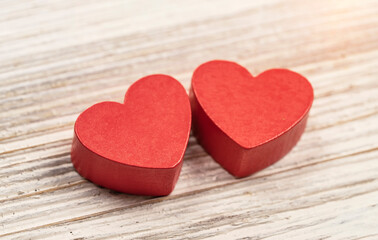Two red handmade wooden carved hearts on wood background,couple relationship Valentine day concept