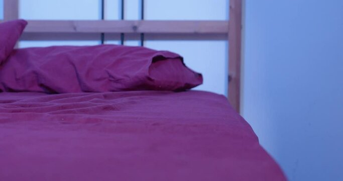 apathetic moroccan woman sits on the bed and remains motionless