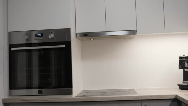 Modern beautiful kitchen interior with oven and cabinets, reveal motion view