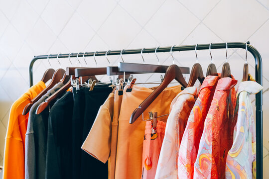 Rack with stylish women's colorful clothes indoors in fashion store