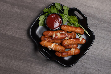Cheese hot dog with tomato sauce. Dark tone.