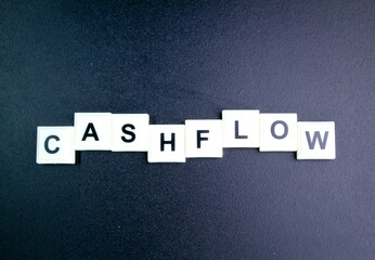 letters of the alphabet with the word cash flow. the concept of cash flow or current income