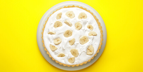 Plate with tasty banana cake on yellow background