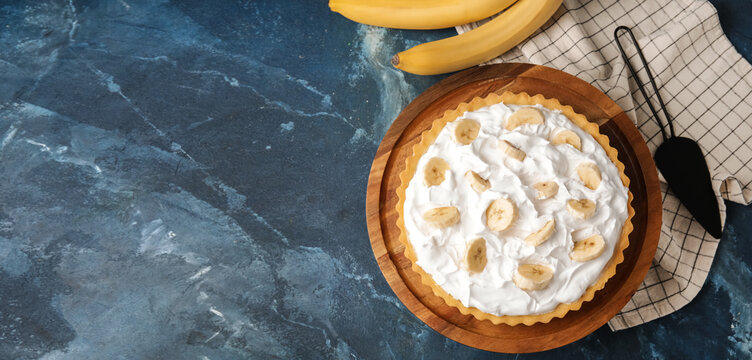 Tasty banana cake on dark blue background with space for text
