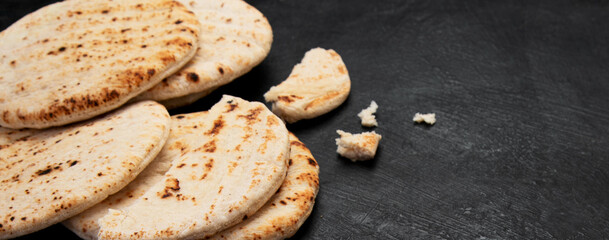 .Pita bread on dark background. Arabic, lebanese bread, traditional food.