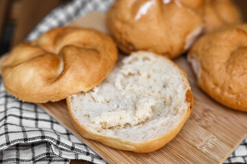 Delicious kaiser rolls on wooden board