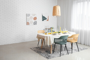 Festive table setting with floral decor in light room interior