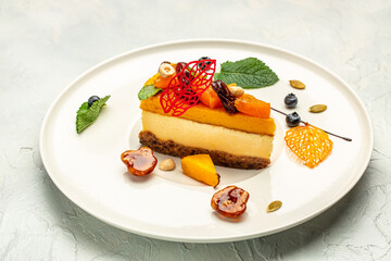 pumpkin cheesecake, slices of pumpkin cheesecake with nuts on a light background. top view