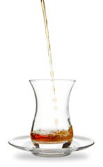 Pouring of Turkish tea into glass on white background