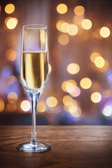 Modern glass of champagne with holiday spirit as the background