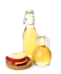 Bottle and jug of apple cider vinegar on white background