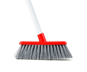 Red cleaning broom on white background, closeup