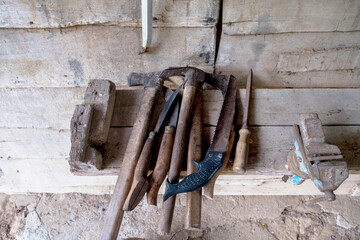 rusty old work tools in wood and old barn. Selective Focus Saw.