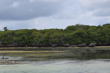 rocks near sea pier. High tide during the day