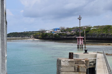 Lighthouse Mast against blue sky with white clouds near harbour, Indonesia.