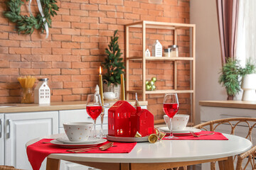 Christmas table setting with candle holders in kitchen