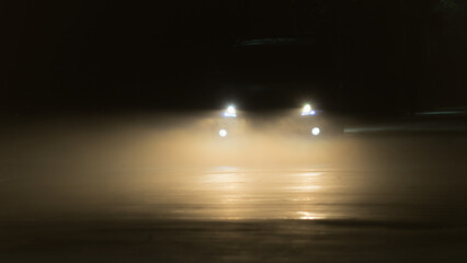 Headlights through the foggy night