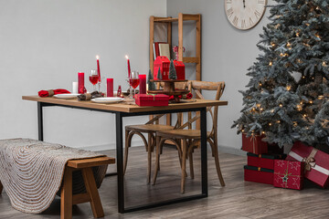 Interior of room with dining table, Christmas tree and presents