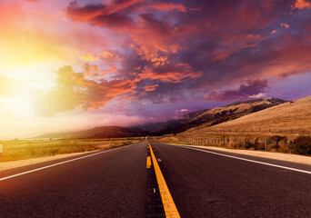 Empty asphalt road at sunset