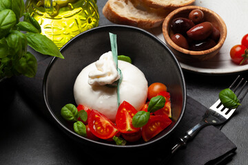 Burrata cheese, various tomatoes and olives