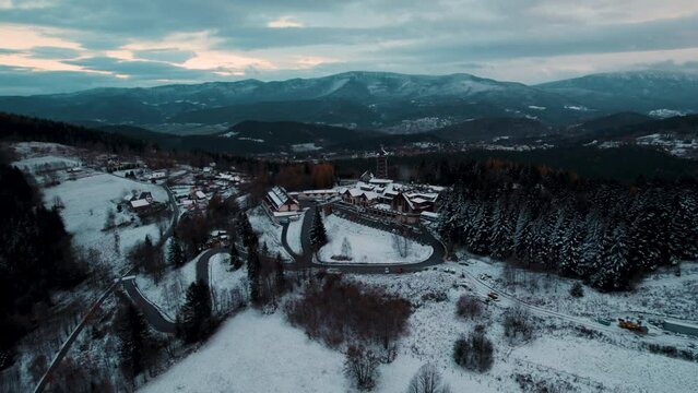 Ski resort in the mountains during winter season. Aerial shot of mountain hotel.