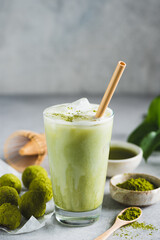 Cold Matcha Latte Ice In Glass With Bamboo Drinking Straw. Healthy Vegan Drink, Coffee Alternative. Copy Space