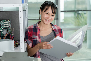 young woman with folder in office