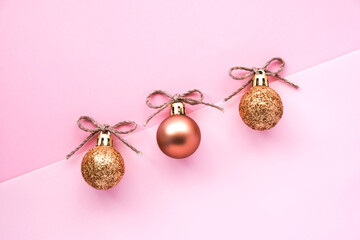 Christmas composition. Pink and glitter balls on a pink background. Flat lay, top view, copy space. New Year's card.