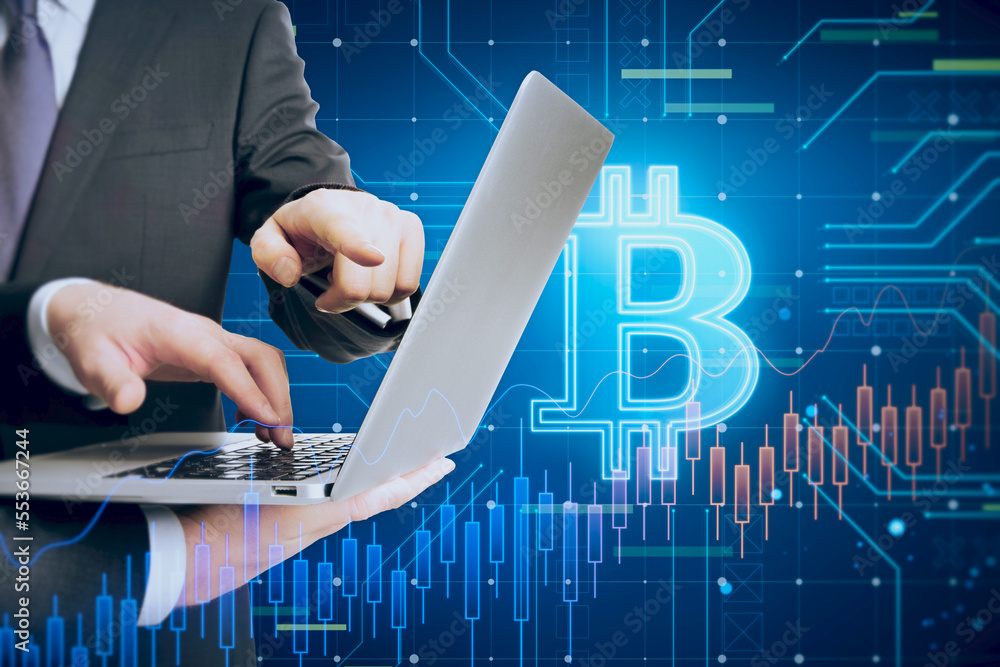 Poster close up of businessmen hands using laptop with glowing bitcoin hologram on blurry background. crypt