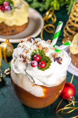 Christmas pudding latte. Sweet coffee drink with whipped cream, vanilla custard creme anglaise, fruit pudding syrup, styled like traditional Christmas english fruit pudding, on cozy decorated backgrou