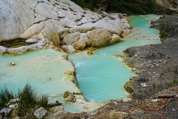 Hot springs at Bagni San Filippo, with calcium carbonate deposits surrounding the thermal water