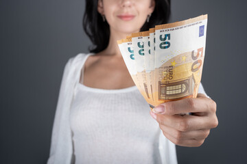 Giving Euro banknotes in fan in nominal 50 EUR. Unfocused Women hold euros in their hands. Europe credit, finance, criminal cash concept. currency paper banknotes bills paying. Selective focus