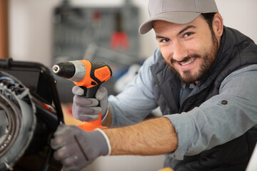car body repair happy young mechanic in garage